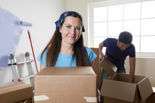 Professional piano movers protecting a piano and property access in Wimbledon