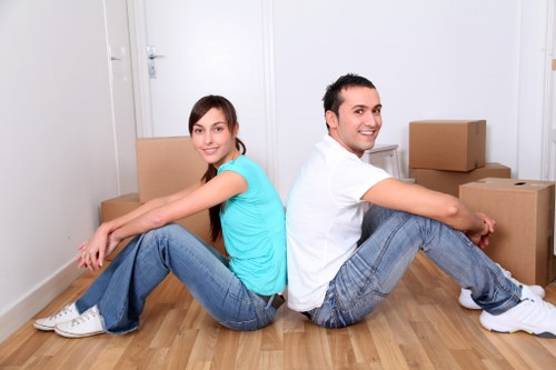 Staff using PPE during a careful furniture move