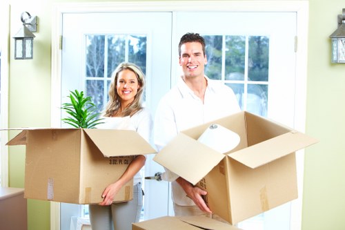 Professional movers loading furniture into a removals van