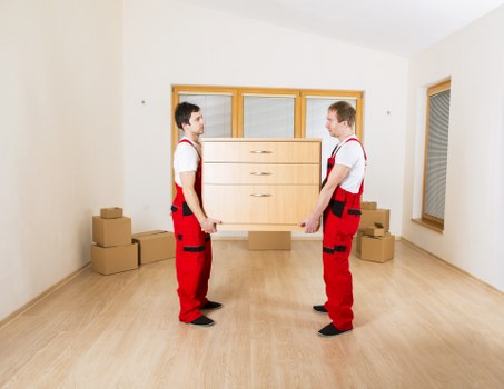 Specialist movers preparing a grand piano for transport in Wimbledon